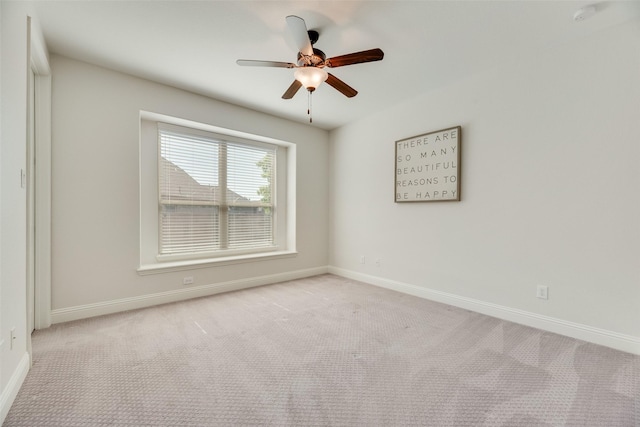 carpeted empty room with baseboards and ceiling fan