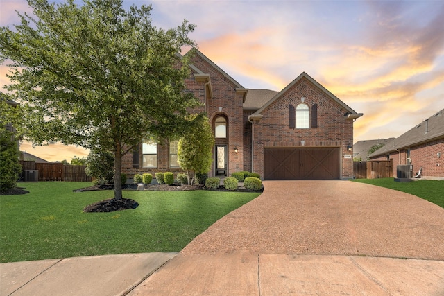 view of front of house with brick siding, fence, and driveway