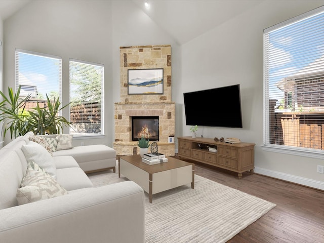 4600 Crossvine Dr, Prosper, TX 75078 - living room featuring healthy amount of natural light, wood finished floors, baseboards, a stone fireplace, and high vaulted ceiling