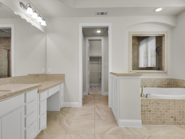 4600 Crossvine Dr, Prosper, TX 75078 - bathroom featuring a tile shower, a spacious closet, vanity, recessed lighting, and tiled bath