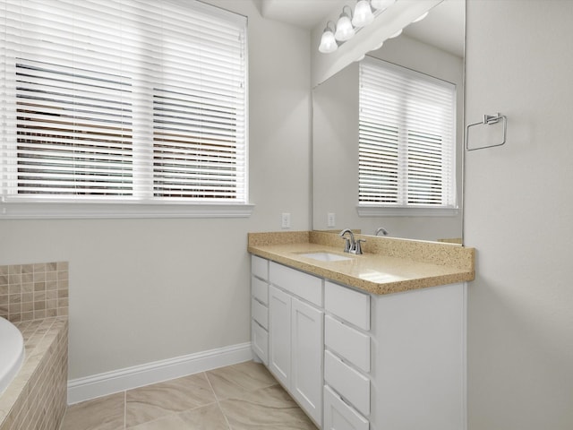 4600 Crossvine Dr, Prosper, TX 75078 - bathroom with vanity, baseboards, and tiled tub