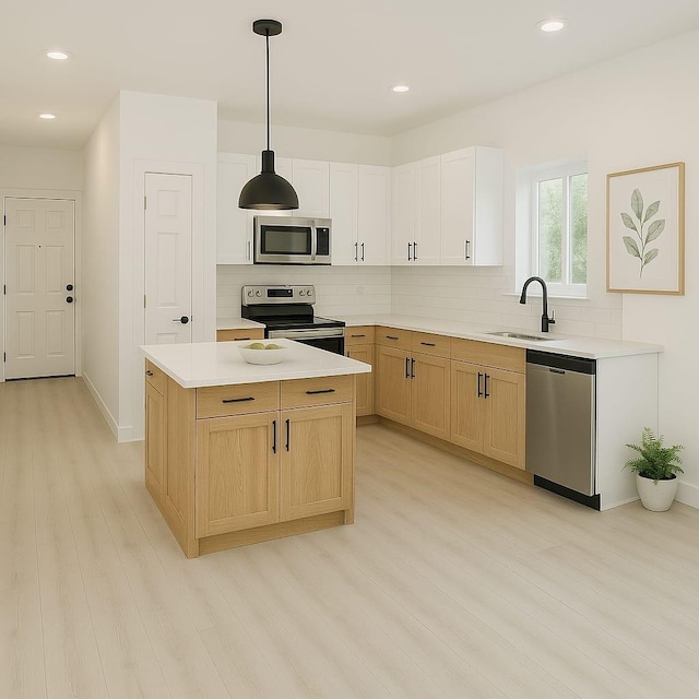 kitchen with appliances with stainless steel finishes, tasteful backsplash, a sink, and light wood-type flooring