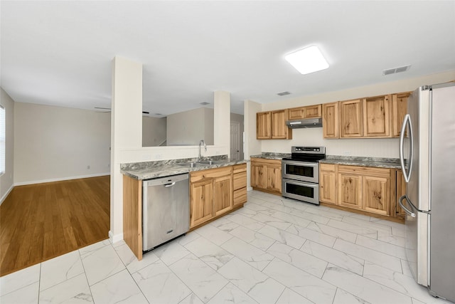 12109 Arbor Lake Rd, Rhome, TX 76078 - kitchen featuring marble finish floor, under cabinet range hood, stainless steel appliances, visible vents, and a sink