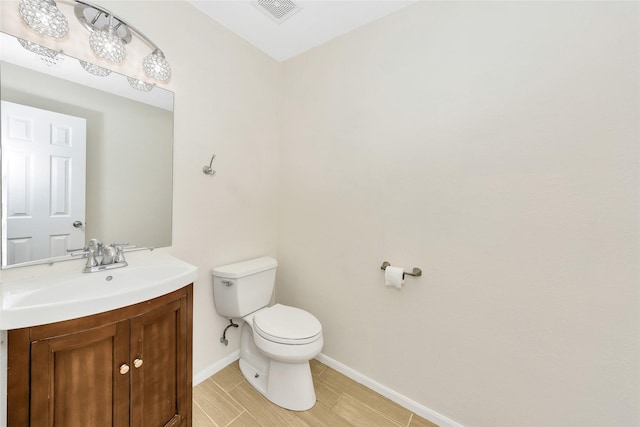 12109 Arbor Lake Rd, Rhome, TX 76078 - half bathroom featuring tile patterned floors, visible vents, toilet, vanity, and baseboards