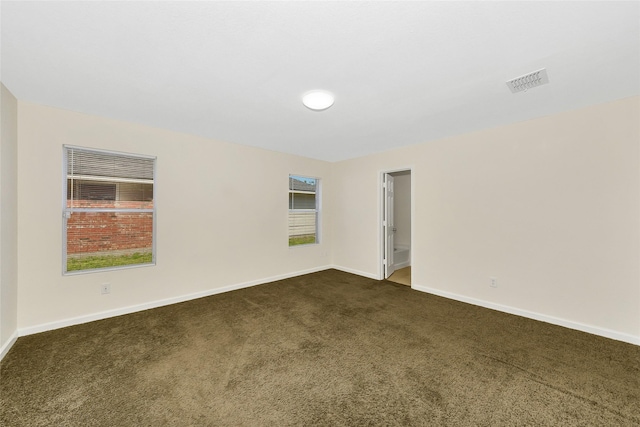 12109 Arbor Lake Rd, Rhome, TX 76078 - spare room featuring dark colored carpet, visible vents, and baseboards