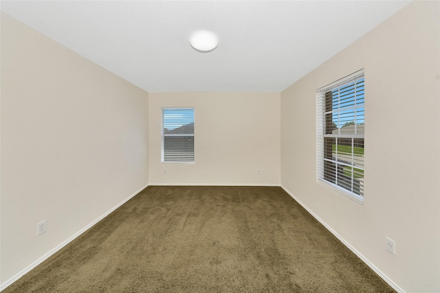 12109 Arbor Lake Rd, Rhome, TX 76078 - unfurnished room with baseboards, a healthy amount of sunlight, and dark colored carpet