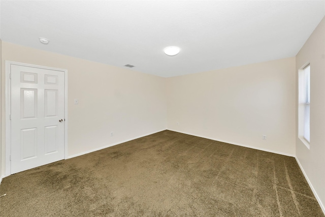 12109 Arbor Lake Rd, Rhome, TX 76078 - unfurnished room with baseboards, dark colored carpet, and visible vents