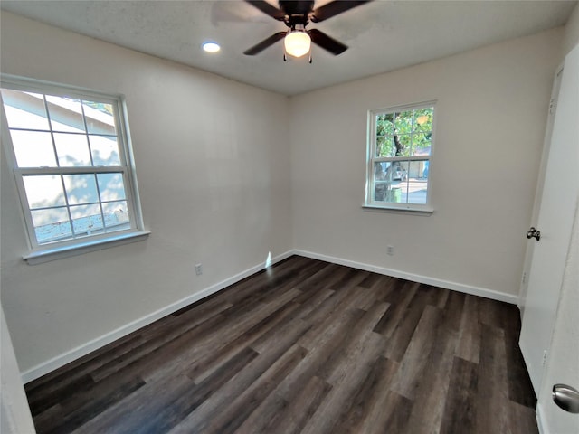 empty room with recessed lighting, dark wood finished floors, a ceiling fan, and baseboards