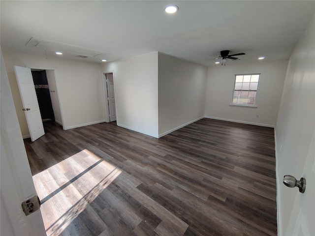 spare room featuring recessed lighting, dark wood-type flooring, baseboards, attic access, and ceiling fan