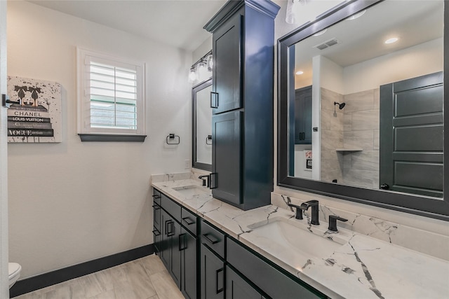 full bathroom with baseboards, visible vents, toilet, and a sink