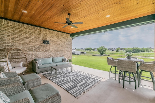 view of patio / terrace featuring outdoor dining space, ceiling fan, and an outdoor living space