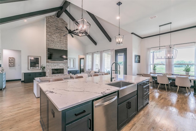 kitchen featuring dishwasher, a notable chandelier, high vaulted ceiling, and a sink