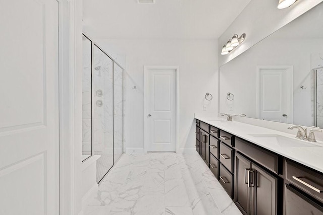 full bath with marble finish floor, a sink, a marble finish shower, and double vanity