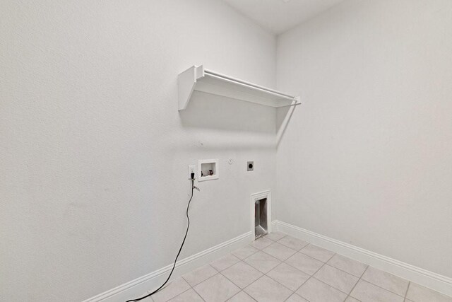 laundry area with laundry area, light tile patterned floors, gas dryer hookup, electric dryer hookup, and washer hookup