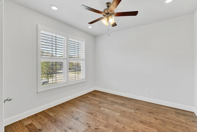 spare room featuring recessed lighting, wood finished floors, baseboards, and ceiling fan