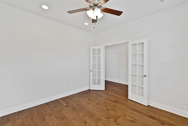 empty room featuring a ceiling fan, wood finished floors, french doors, baseboards, and recessed lighting