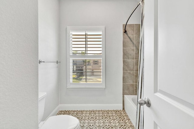 bathroom featuring shower / bath combination, baseboards, and toilet