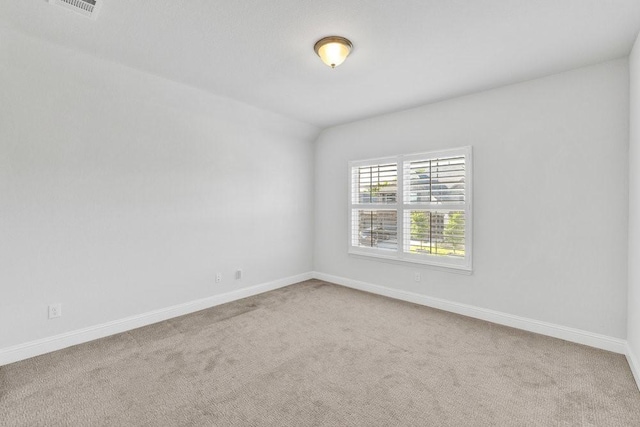 carpeted empty room with visible vents and baseboards