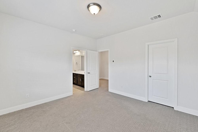 unfurnished bedroom with baseboards, visible vents, and light colored carpet