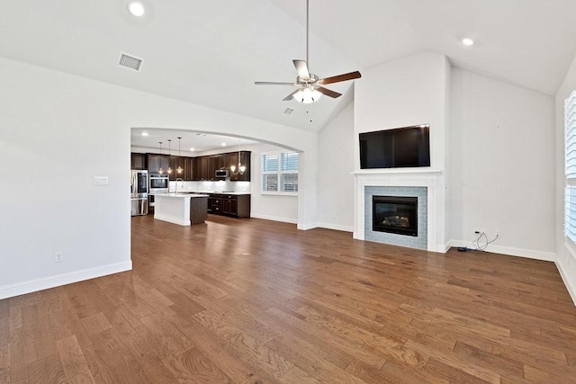 unfurnished living room featuring recessed lighting, visible vents, a sink, a glass covered fireplace, and ceiling fan