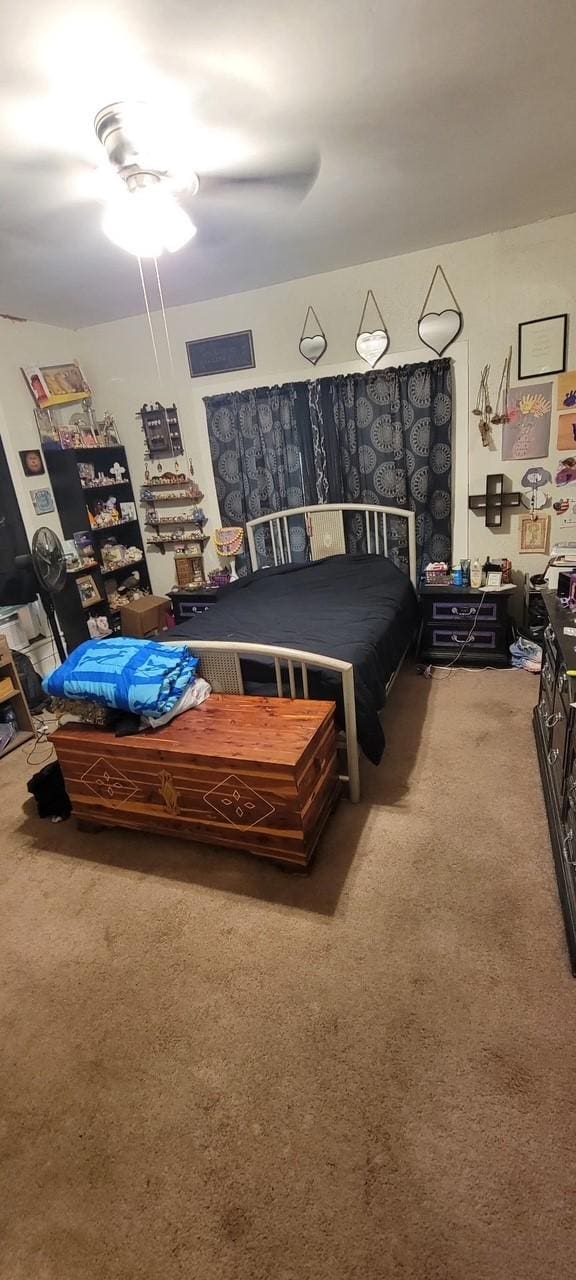 bedroom with a ceiling fan and carpet flooring