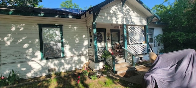 back of property featuring a porch