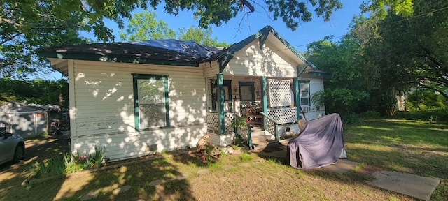 bungalow featuring a porch and a front yard