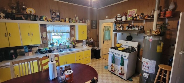 kitchen featuring yellow cabinetry, a sink, water heater, open shelves, and white gas range