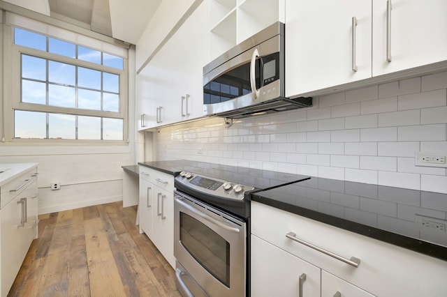kitchen with white cabinets, dark countertops, and stainless steel appliances
