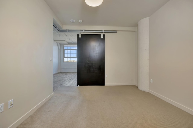 unfurnished room with baseboards and carpet flooring