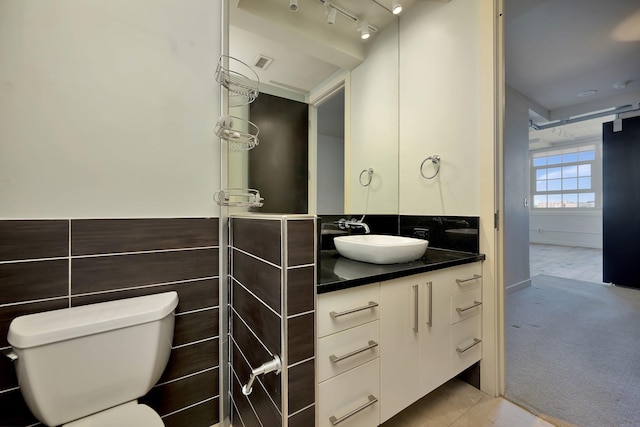bathroom with visible vents, vanity, and toilet