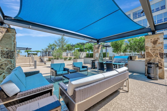 view of patio / terrace featuring an outdoor kitchen, grilling area, and an outdoor hangout area