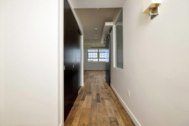 hall with hardwood / wood-style flooring and baseboards