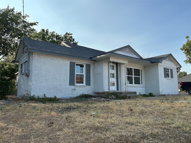 single story home featuring a porch and brick siding