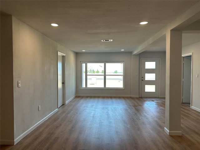 interior space with recessed lighting, wood finished floors, visible vents, and baseboards