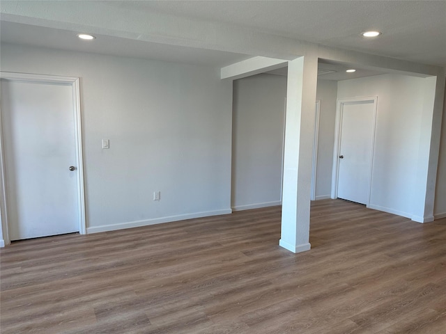 below grade area with wood finished floors, baseboards, and recessed lighting