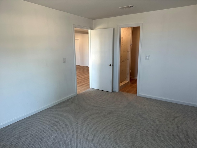 unfurnished bedroom featuring visible vents, carpet flooring, and baseboards