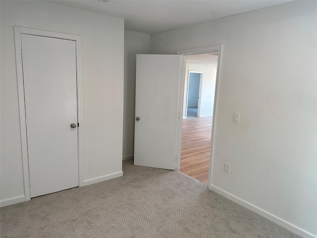 unfurnished bedroom with baseboards and carpet floors
