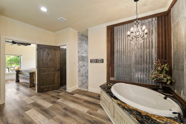 full bathroom featuring a whirlpool tub, wood finished floors, crown molding, baseboards, and a notable chandelier