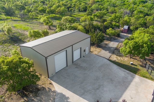 detached garage featuring a wooded view