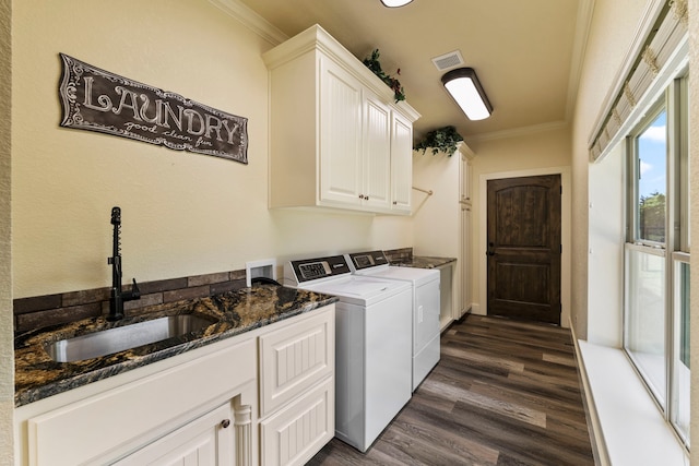 washroom featuring a sink, cabinet space, washer and clothes dryer, dark wood-type flooring, and crown molding