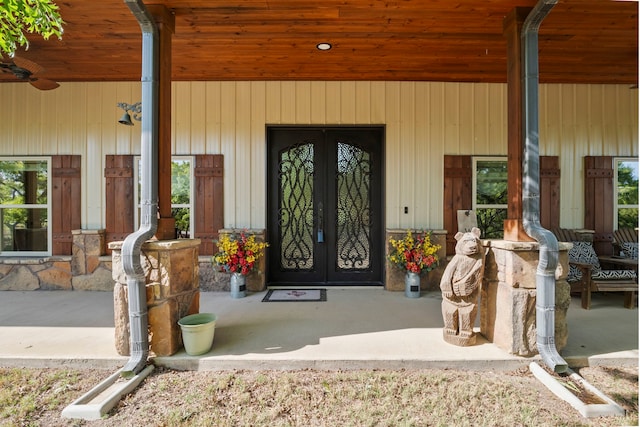 doorway to property featuring french doors and covered porch