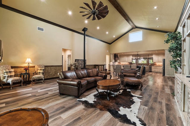 living room featuring wood finished floors, visible vents, beamed ceiling, a chandelier, and high vaulted ceiling