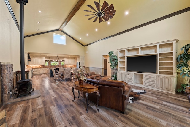 living room featuring recessed lighting, wood finished floors, a wood stove, beam ceiling, and high vaulted ceiling