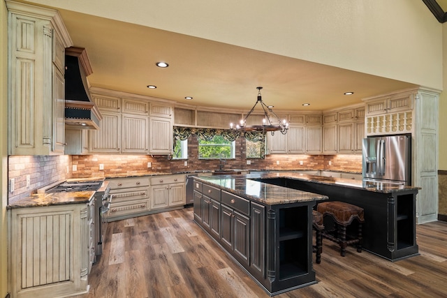 kitchen featuring dark wood-style floors, open shelves, a kitchen island, appliances with stainless steel finishes, and cream cabinets