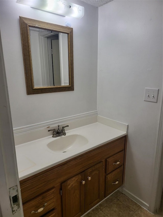 bathroom featuring tile patterned flooring and vanity