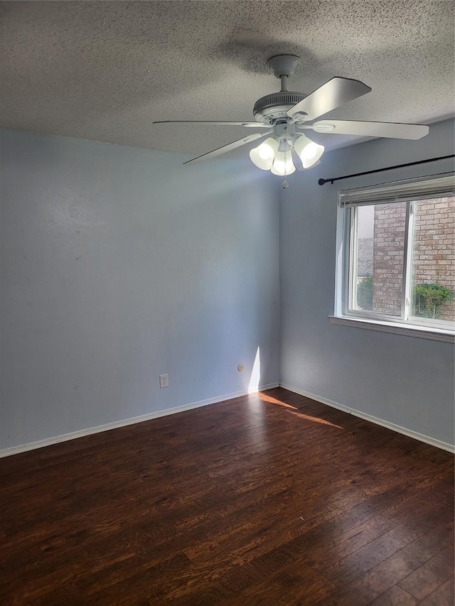unfurnished room with a ceiling fan, wood finished floors, and a textured ceiling