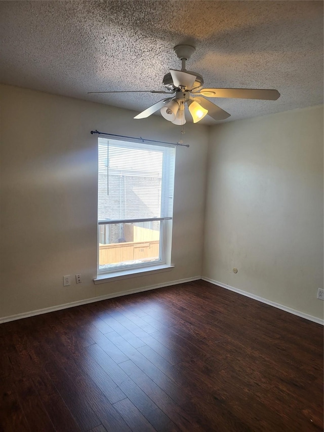 spare room with wood finished floors, a textured ceiling, baseboards, and ceiling fan
