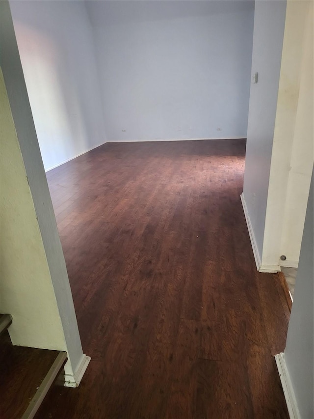 spare room featuring dark wood-style floors