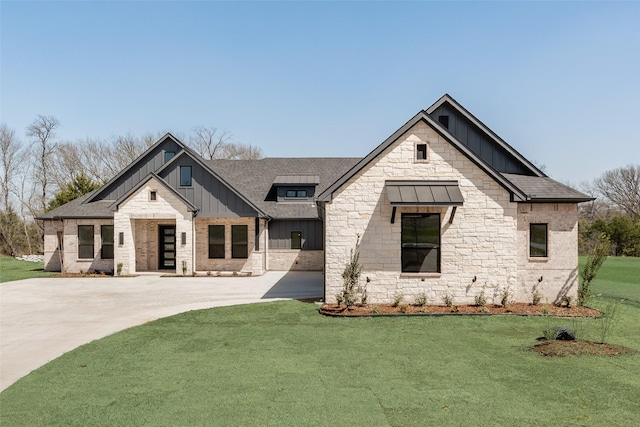 view of front of home featuring a front lawn, stone siding, concrete driveway, a shingled roof, and board and batten siding